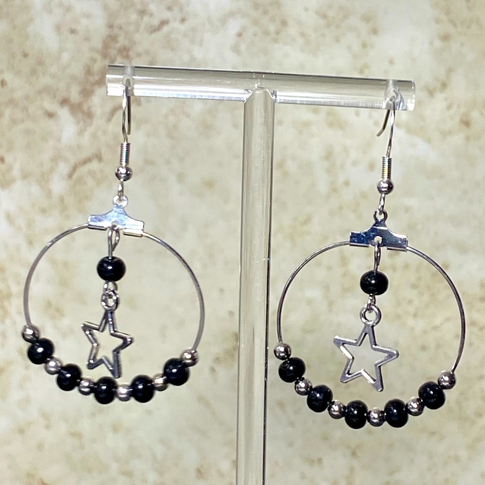 Silver tone hoop earrings with obsidian beads and star charm